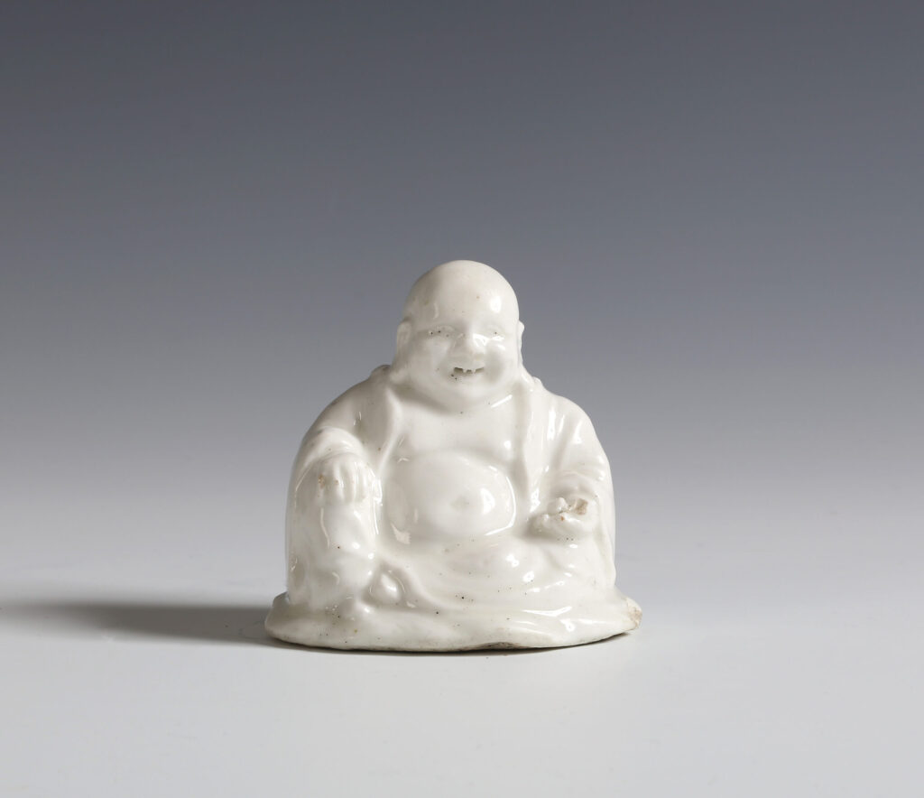 A CHELSEA FIGURE OF BUDAI