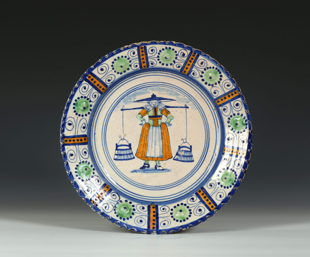 A DUTCH TIN-GLAZED ‘MAJOLICA’ DISH WITH A MILKMAID