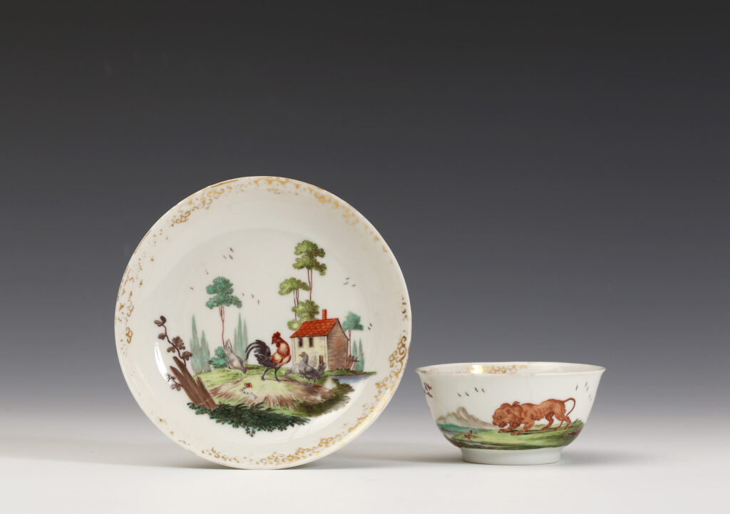 A Chinese porcelain teabowl and saucer decorated in London