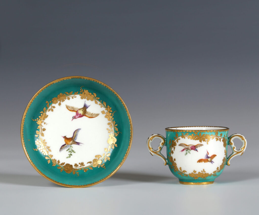A VINCENNES GREEN-GROUND TWO-HANDLED SMALL CUP AND SAUCER (TASSE À TOILETTE ET SOUCOUPE)