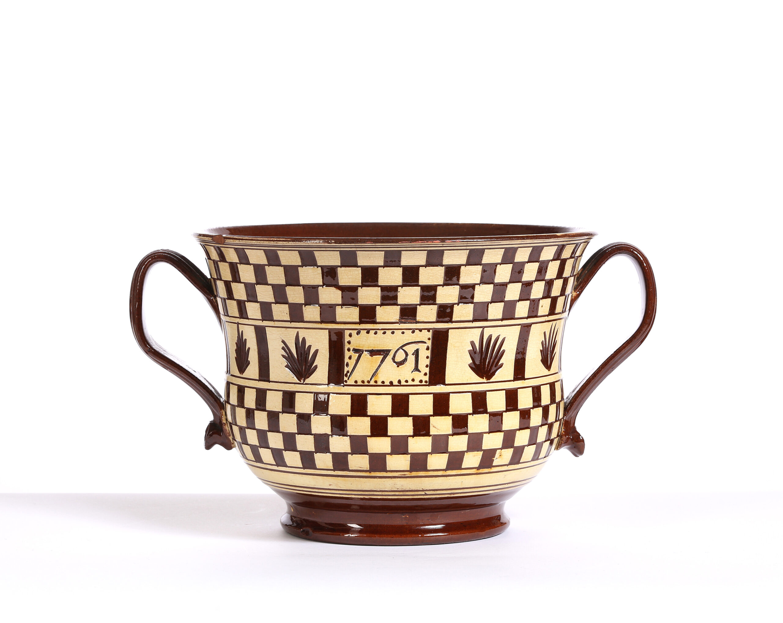 A STAFFORDSHIRE SLIPWARE POSSET CUP