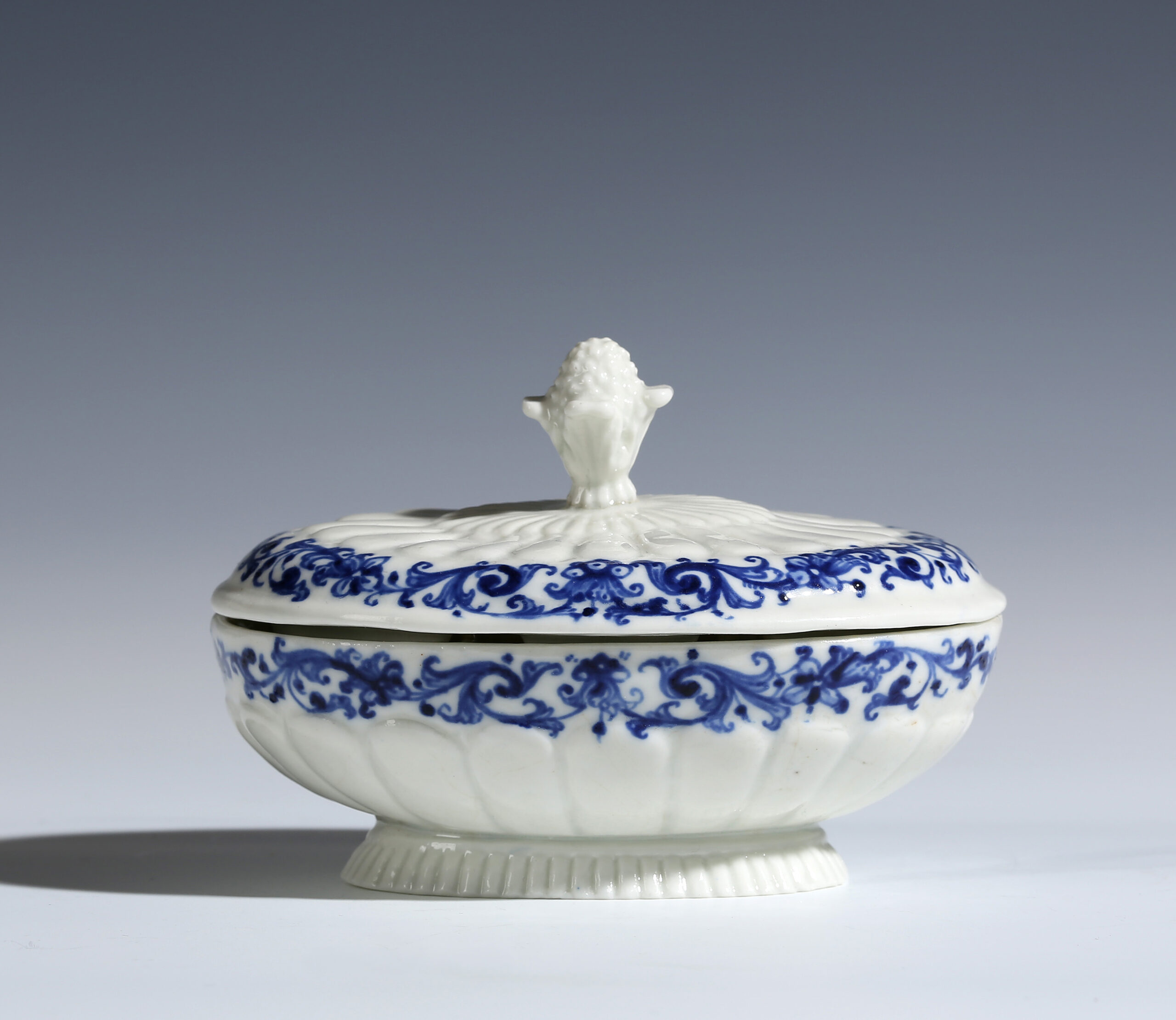 A SAINT-CLOUD BLUE AND WHITE OVAL TRIPLE SPICE BOX AND COVER