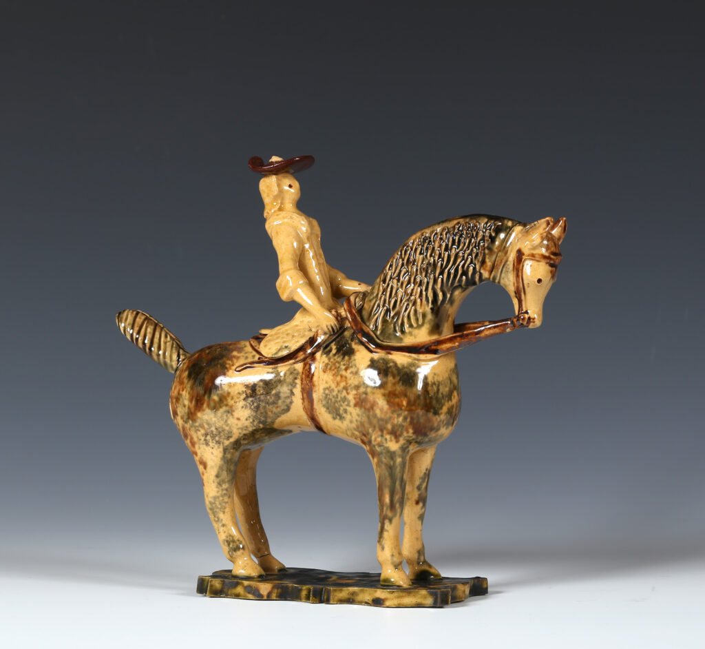 A STAFFORDSHIRE FIGURE OF A HORSEWOMAN