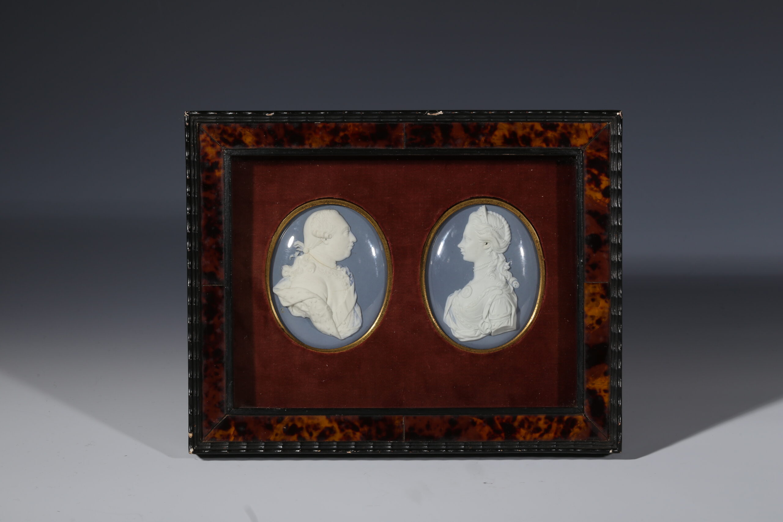 A pair of Wedgwood and Bentley medallions of George III and Queen Charlotte