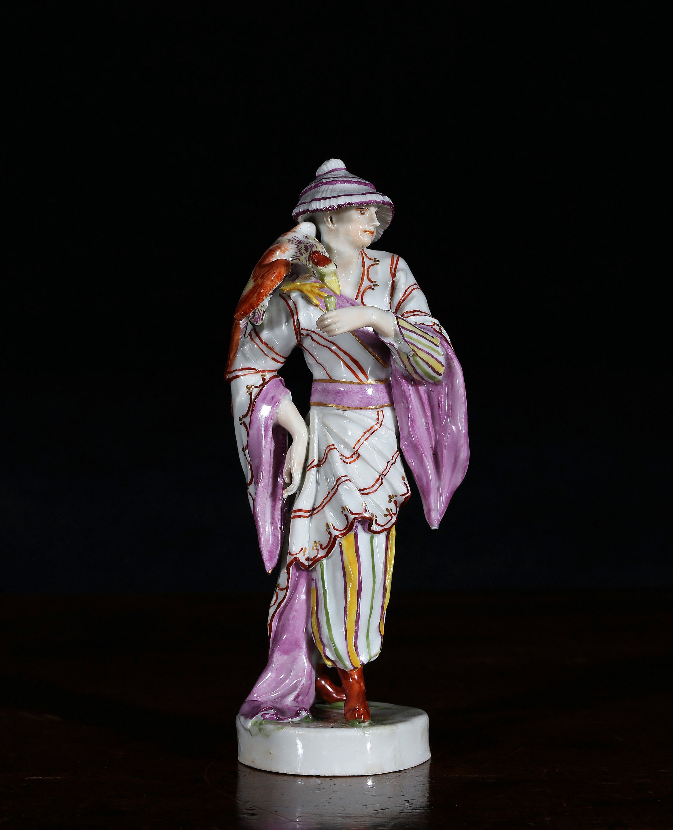 A Ludwigsburg figure of a Chinaman with an exotic bird