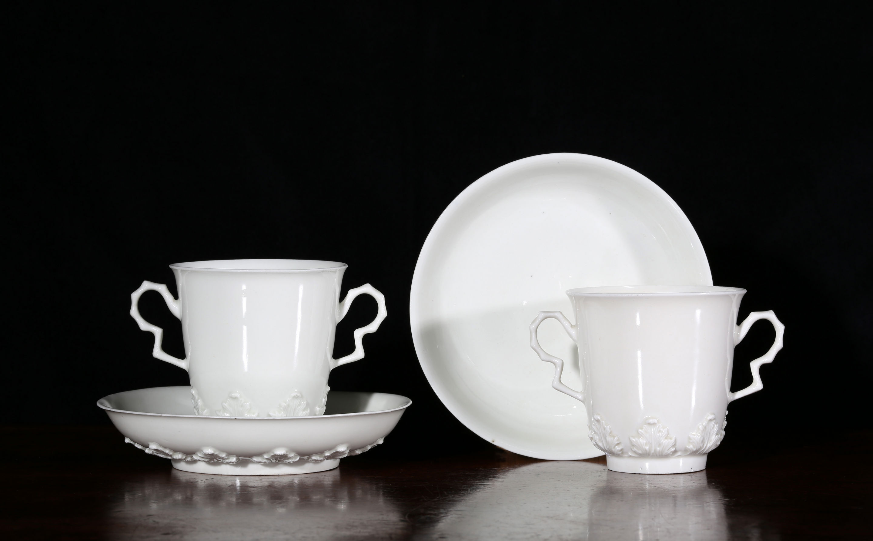 A pair of Meissen, Böttger porcelain two-handled beakers and saucers